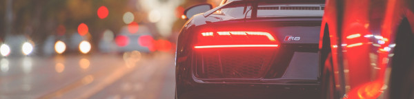 Head banner, car on the street.